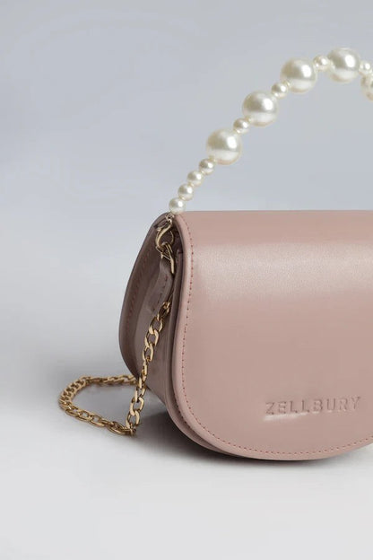 Canvas By Usman pink faux leather mini handbag with pearl handle and gold chain strap.