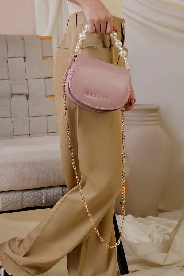 Canvas By Usman pink faux leather mini handbag with pearl handle and gold chain strap.